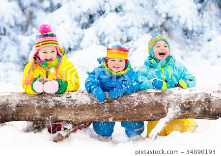 Kids playing in snow. Children play in snowfall. Kids playing in snow. Children play in snowfall. 34890193
