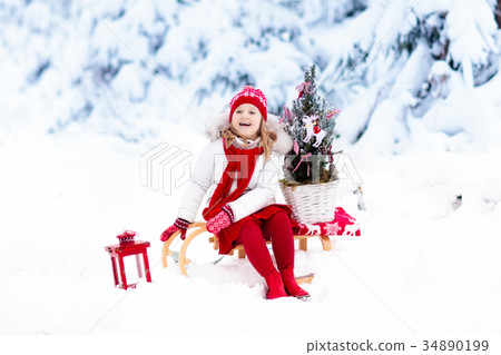 Children with Christmas tree. Snow winter fun 34890199