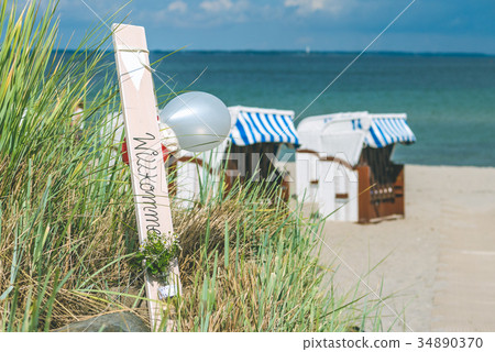 Blue colored roofed chairs on sandy beach in Blue colored roofed chairs on sandy beach in 34890370