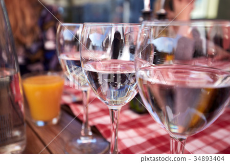 Row of pure drinking water glasses at summer Row of pure drinking water glasses at summer 34893404