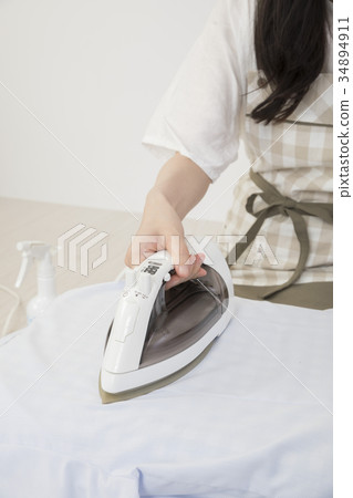 Housewife hand doing ironing 34894911