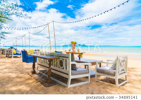 Chair and table dinning on the beach and sea with blue sky Chair and table dinning on the beach and sea with blue sky 34895141