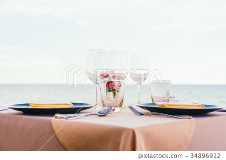 Romantic dining table setting with wine glass and other Romantic dining table setting with wine glass and other 34896912