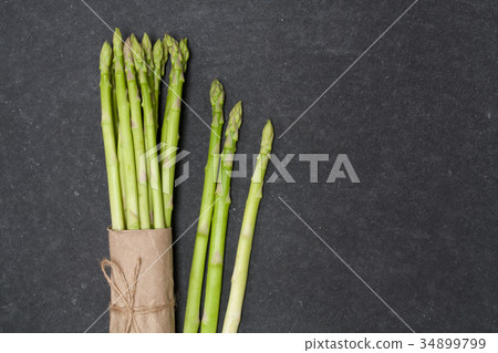bunch of asparagus over slate 34899799
