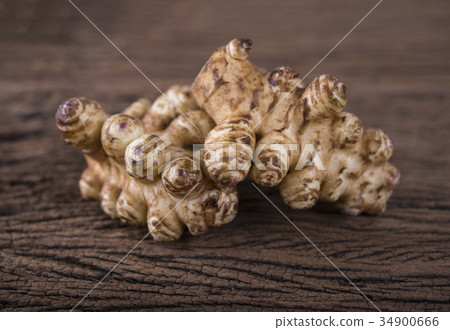 whole fresh Jerusalem Artichoke on wooden 34900666