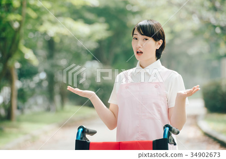 Wheelchair and young carer helper woman 34902673