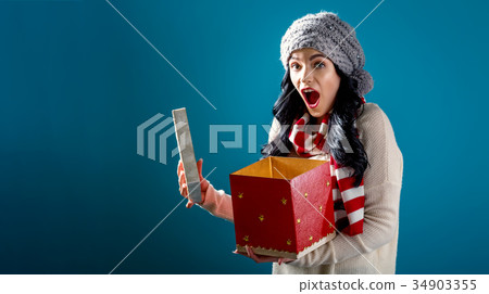 Happy young woman with Christmas present box 34903355