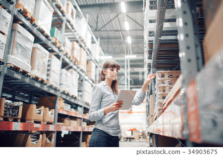 stock taking. beautiful young woman worker of 34903675