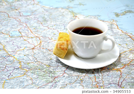 cup of coffee with a snack on the map. concept cup of coffee with a snack on the map. concept 34905553
