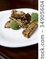 baked pork ribs on a white plate 34905604