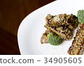baked pork ribs on a white plate 34905605