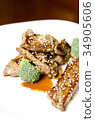 baked pork ribs on a white plate 34905606