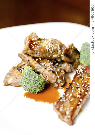 baked pork ribs on a white plate baked pork ribs on a white plate 34905606