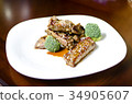 baked pork ribs on a white plate 34905607