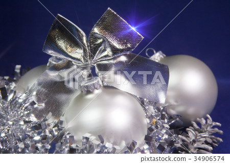 New Year balls and tinsel on a blue background New Year balls and tinsel on a blue background 34906574