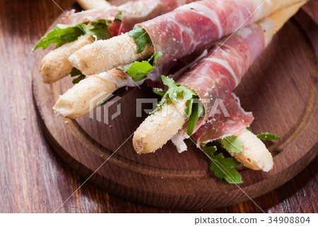 Italian grissini with ham prosciutto, mozzarella 34908804