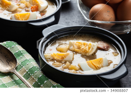 The sour soup made of rye flour with eggs 34908807