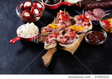 Spanish tapas with slices jamon serrano Spanish tapas with slices jamon serrano 34908820
