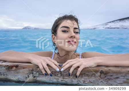 Girl relaxing in geothermal pool outdoors Girl relaxing in geothermal pool outdoors 34909299