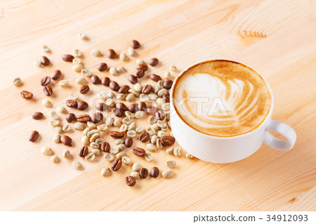 Cup of cappuccino coffee with beans on table Cup of cappuccino coffee with beans on table 34912093