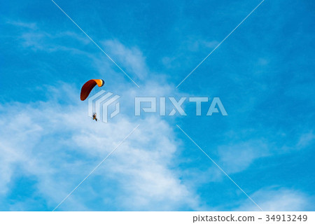 man ride Paramotor flying in the sky 34913249