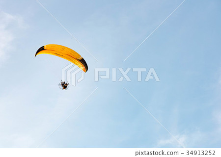 man ride Paramotor flying in the sky man ride Paramotor flying in the sky 34913252