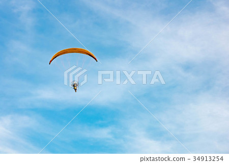 man ride Paramotor flying in the sky 34913254