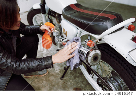 Wiping Dirt from Motorcycle 34916147