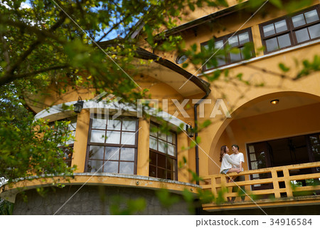 Young couple on balcony Young couple on balcony 34916584