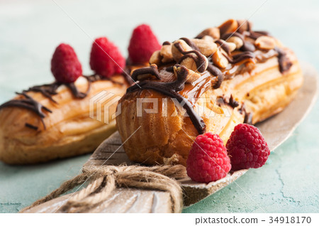 Eclairs with peanuts, chocolate icing Eclairs with peanuts, chocolate icing 34918170