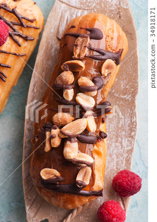 Eclairs with peanuts, chocolate icing Eclairs with peanuts, chocolate icing 34918171