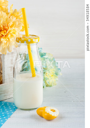 Bottle of milk with straw and yellow heart Bottle of milk with straw and yellow heart 34918584