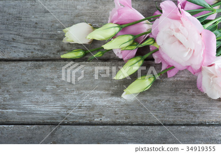 Pink eustomas on old wooden board Pink eustomas on old wooden board 34919355