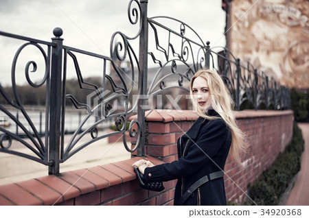 Beautiful woman posing on embankment of the European city Beautiful woman posing on embankment of the European city 34920368