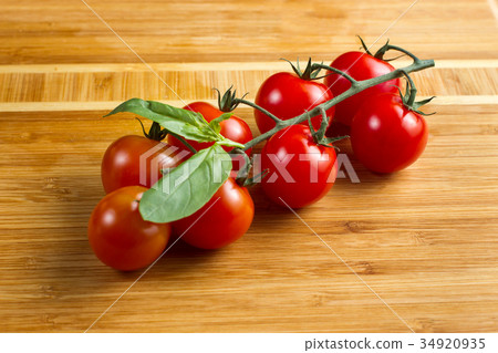 Cherry tomatoes on wooden background Cherry tomatoes on wooden background 34920935
