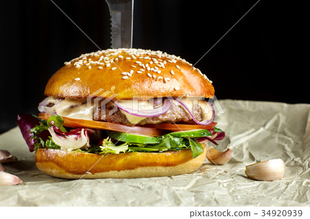 Hamburger with garlic is on kraft paper. 34920939