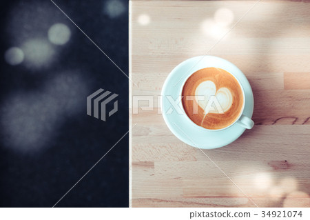 Cappuccino white cup with heart shaped latte art Cappuccino white cup with heart shaped latte art 34921074