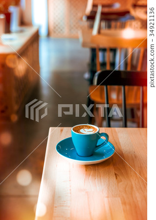 Coffee in blue cup against sunlight Coffee in blue cup against sunlight 34921136