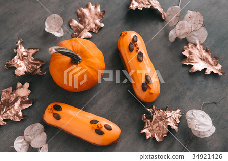 Pumpkin eclairs on dark background 34921426