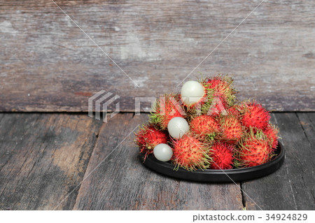 rambutan sweet fruit fresh in plate on wood rambutan sweet fruit fresh in plate on wood 34924829