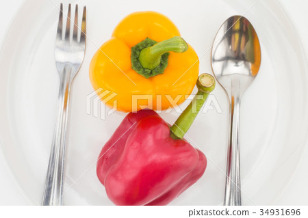diet concept. Yellow and red pepper on plate. diet concept. Yellow and red pepper on plate. 34931696