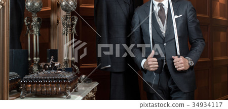Tailor hands expensive tailoring individual suits Tailor hands expensive tailoring individual suits 34934117
