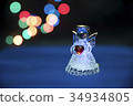 Glass angel holding heart 34934805