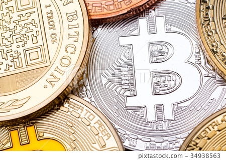 Silver bitcoin as a background and some coins. Silver bitcoin as a background and some coins. 34938563