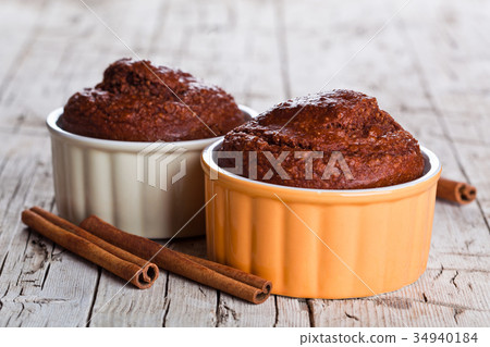 two fresh baked browny cakes and cinnamon sticks 34940184