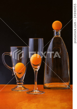 Still life with orange balls and glass objects Still life with orange balls and glass objects 34940455