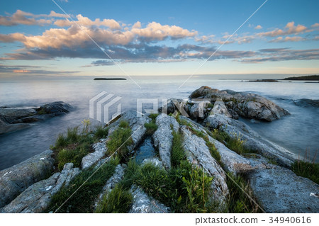 Evening landscape of stony coast of the lake 34940616