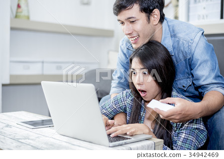 Lover are surprising when using the laptop. Family Lover are surprising when using the laptop. Family 34942469