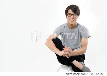 Young man portrait sitting down and holding hands Young man portrait sitting down and holding hands 34942480