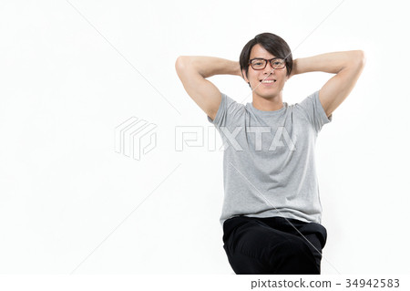Young men cross hands behind their heads Young men cross hands behind their heads 34942583